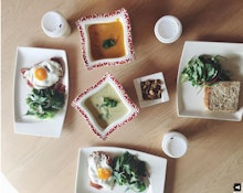 Plates with healthy soups, omelets and salads