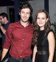 Leighton Meester and Adam Brody smiling while looking at the camera