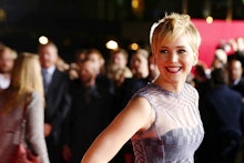 Jennifer Lawrence in a sleeveless grey dress and short haircut at a red carpet