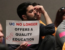 A student holding a sign that says "UC no longer offers a quality education"