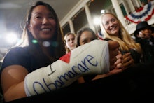 A brunette woman with an arm cast with the text 'I love Obamacare'