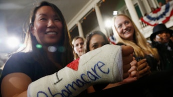 A brunette woman with an arm cast with the text 'I love Obamacare'