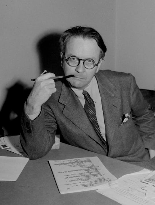 Raymond Chandler holding pen while looking directly into the camera