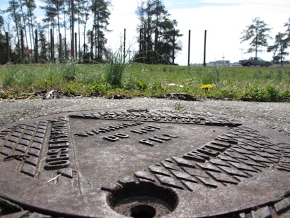 A close-up of a metal shaft on a road