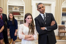 Barack Obama posing for a photo with McKayla Maroney, both making silly faces pushing their lips to ...