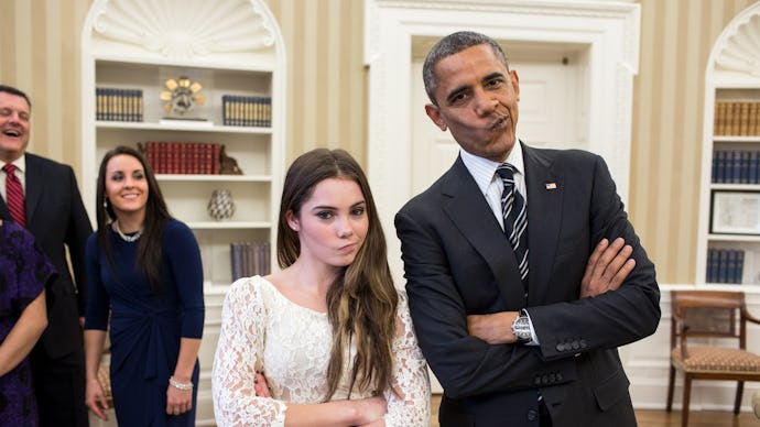 Barack Obama posing for a photo with McKayla Maroney, both making silly faces pushing their lips to ...