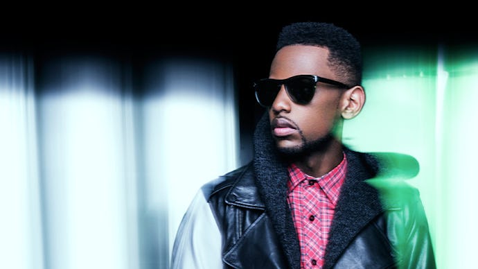 Fabolous wearing dark shades, red checked shirt and a black-and-white leather jacket