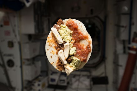 A burrito flying in the air at a space station