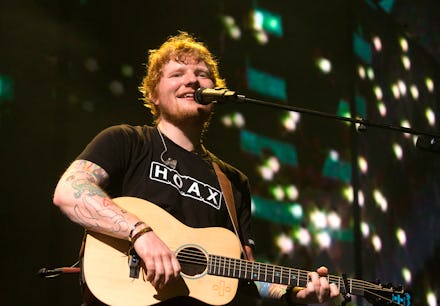 Ed Sheeran performing on stage with a guitar