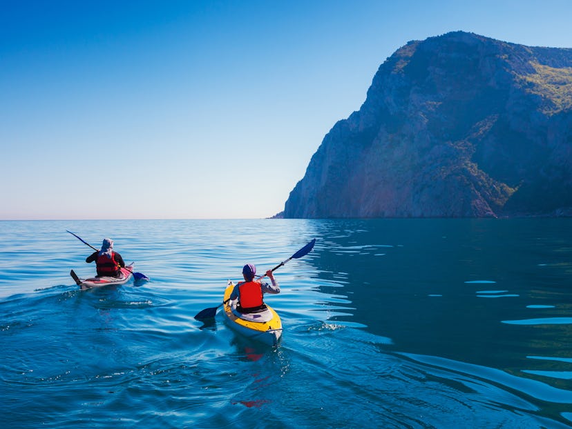 Two tourists kayaking in the sea