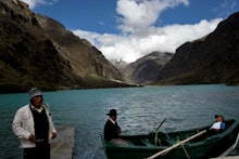 Three local men in their boats on Lake Chinancocha (Llanganuco)