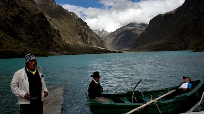Three local men in their boats on Lake Chinancocha (Llanganuco)