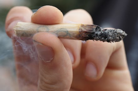 A hand holding a medical marijuana joint