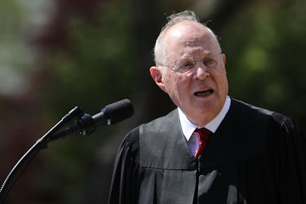Justice Anthony Kennedy speaking into a microphone