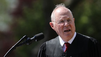 Justice Anthony Kennedy speaking into a microphone