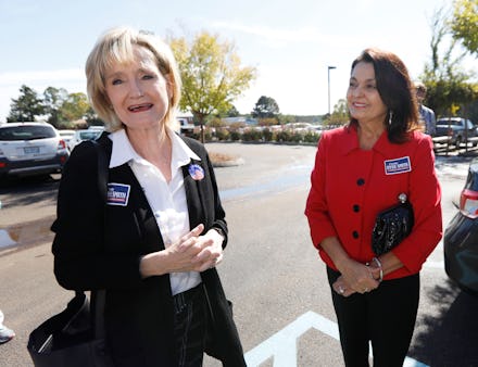Mississippi Republican Sen. Cindy Hyde-Smith with a member of her staff at a parking lot