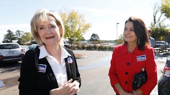 Mississippi Republican Sen. Cindy Hyde-Smith with a member of her staff at a parking lot
