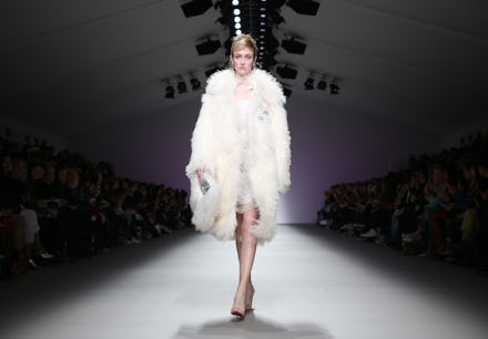 A model going down the runway wearing a fur coat