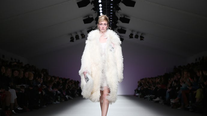 A model going down the runway wearing a fur coat