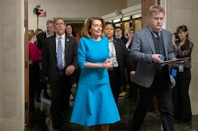 Nansi Pelosi in a blue dress after she wins Democratic nomination for leader as opposition rumbles