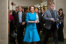 Nansi Pelosi in a blue dress after she wins Democratic nomination for leader as opposition rumbles