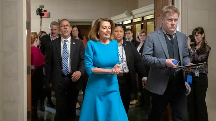 Nansi Pelosi in a blue dress after she wins Democratic nomination for leader as opposition rumbles