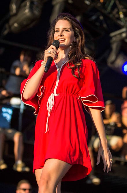 Lana Del Rey wearing a red dress while performing her new song