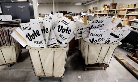 Two baskets filled with pamphlets reading 'Vote here.'
