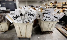 Two baskets filled with pamphlets reading 'Vote here.'