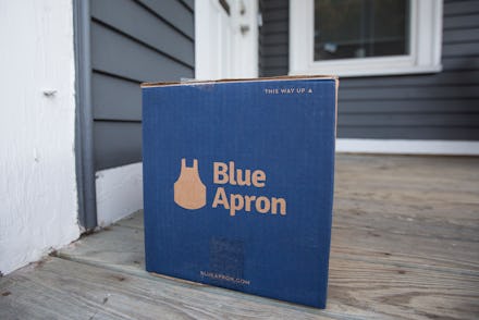 A box of Blue Apron in front of the front door of a house