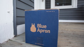 A box of Blue Apron in front of the front door of a house