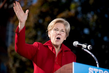 Elizabeth Warren wearing a red coat during her speech