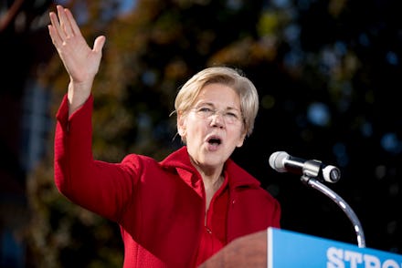 Elizabeth Warren wearing a red coat during her speech