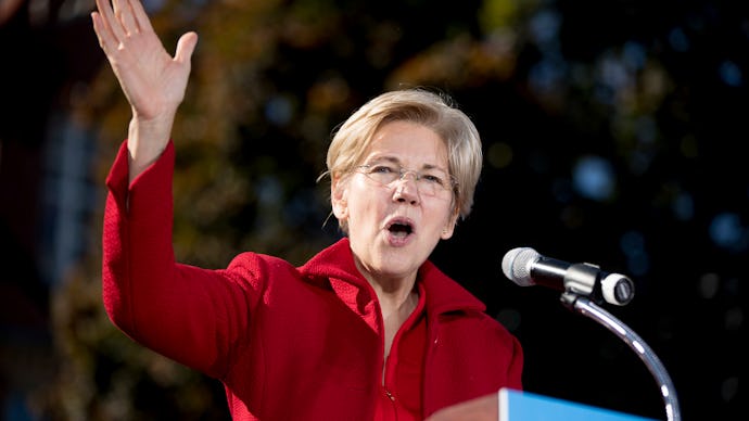 Elizabeth Warren wearing a red coat during her speech