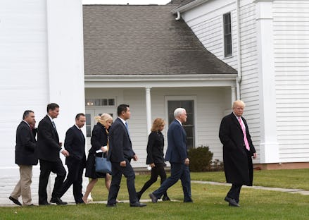 Donald Trump walking in front of the members of his Cabinet