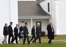 Donald Trump walking in front of the members of his Cabinet