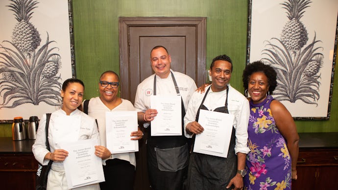 Four of America's best Black chefs posing for a picture with certificate awards