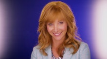 Lisa Kudrow with ginger hair in a light blue blazer