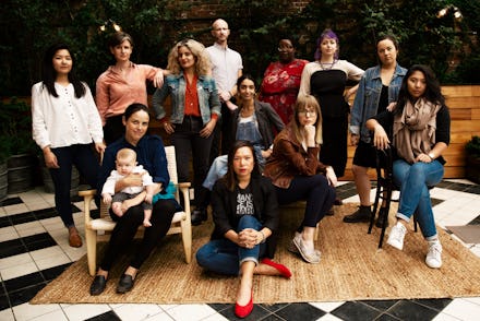 Group of women that are working in restaurants posing for a photo in front of a restaurant