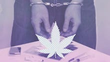 The hands of a handcuffed person and a marijuana leaf illustration in the center of the photo 