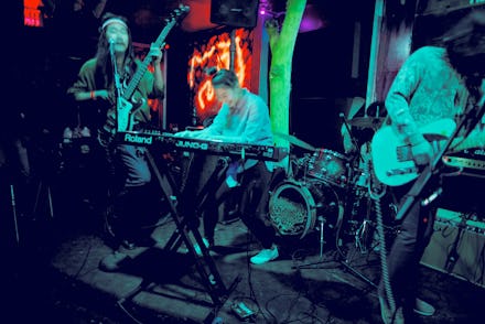 Goonam on stage performing with blue-toned lighting