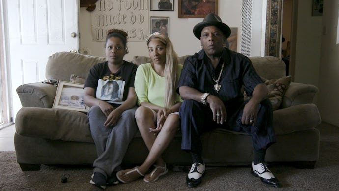 David Phillips Sr. and Desmond Phillips’ siblings sitting on a couch in their home