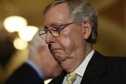 Mitch McConnell wearing a formal suit and eyeglasses