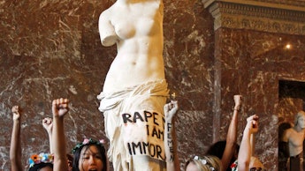 Women protesting topless in front of the venus de milo