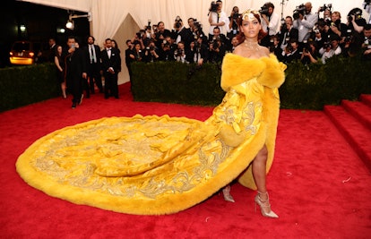 Rihanna at the MET gala wearing a yellow dress created by a chinese designer