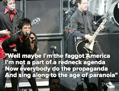 Green Day performing on stage, with the lyrics to "American Idiot"