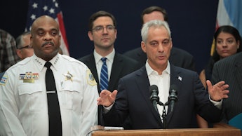 Rahm Emanuel, the mayor of Chicago standing at a podium, talking about the city suing the Trump admi...