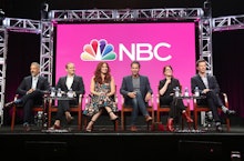 the cast of ‘Will & Grace’ sitting on a panel in front of the nbc logo