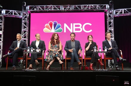 the cast of ‘Will & Grace’ sitting on a panel in front of the nbc logo