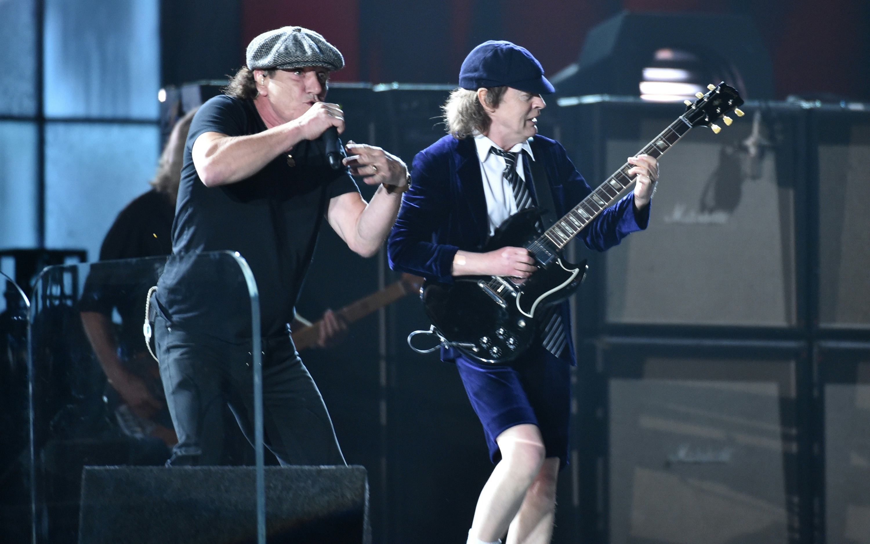 ACDC playing live on stage at the grammys while using a teleprompter